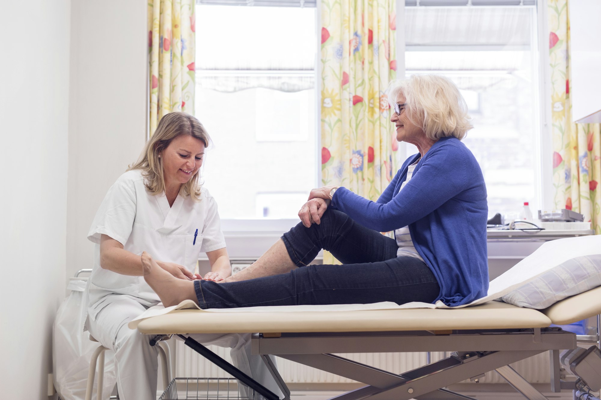 Senior woman with doctor during medical procedure